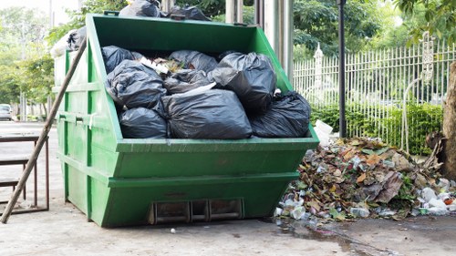 Crew separating recyclable materials and hazardous waste at a clearance site